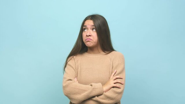 Young cute woman unhappy looking in camera with sarcastic expression