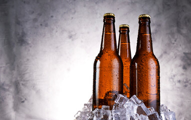 Cold light beer with water drops, beer bottles with ice cubes