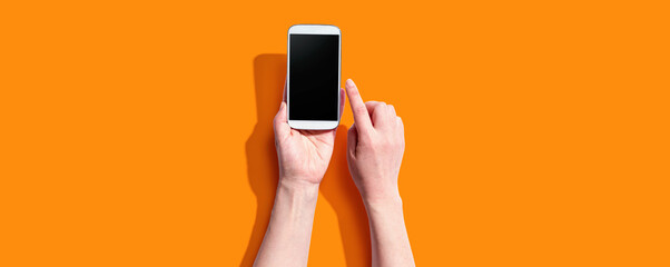 Person using a white smartphone from above
