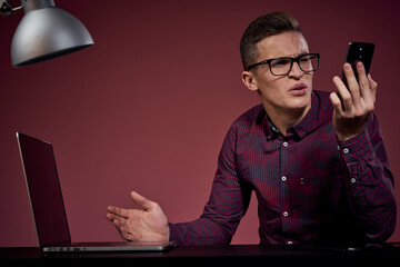 Business man in office and talking on the phone manager red background model cropped view of laptop tablet