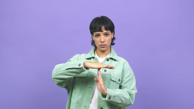 Young caucasian woman tired and bored, doing a timeout gesture, needs to stop because of work stress, time concept