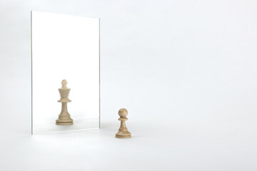 reassessment of their abilities. the pawn is reflected in the mirror like a king - obrazy, fototapety, plakaty