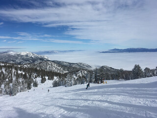 Winter landscape view over Carson Valley hidden underneath clouds, as seen from Heavenly mountain...