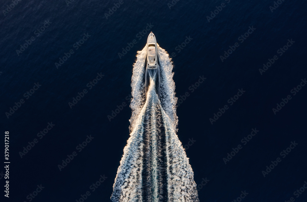 Wall mural aerial view on fast boat on blue mediterranean sea at sunny day. fast ship on the sea surface. seasc