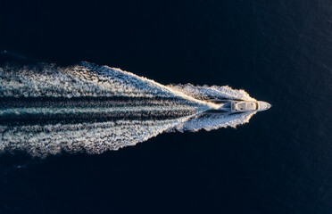 Aerial view on fast boat on blue Mediterranean sea at sunny day. Fast ship on the sea surface....