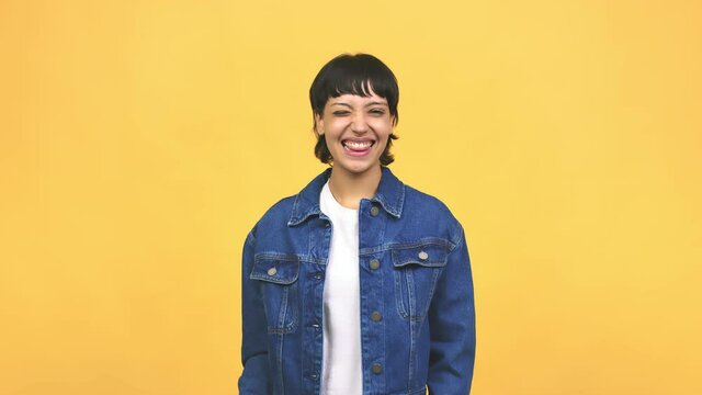 Young caucasian woman winking, funny joke, symbol of agreement or complicity