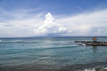 Naklejka premium Small Balinese temple on the sea in a sunny day, Bali, Indonesia. 