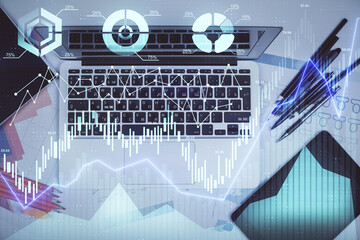 Multi exposure of forex chart drawing over table background with computer. Concept of financial research and analysis. Top view.