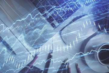 Double exposure of financial chart drawing over table background with computer. Concept of research and analysis. Top view.