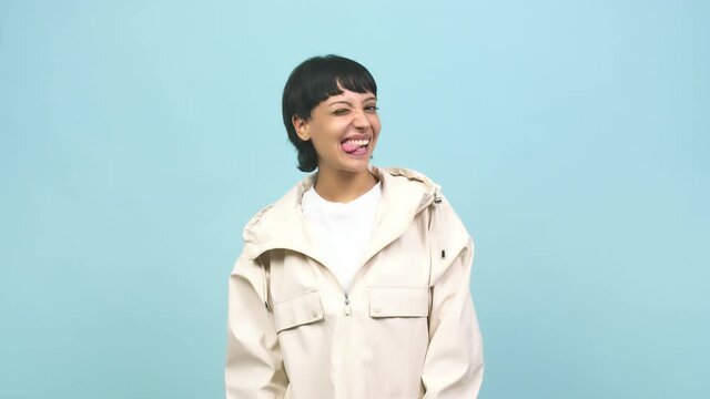 Young caucasian woman winking, funny joke, symbol of agreement or complicity