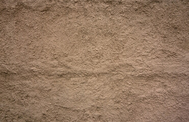 Texture of a yellow concrete wall on the street
