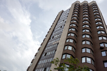 Multi-storey residential building of brown color bottom-up view