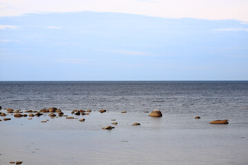 Sea with stones and blue sky