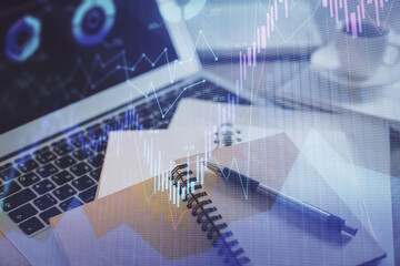 Double exposure of financial chart drawing and desktop with coffee and items on table background. Concept of forex market trading