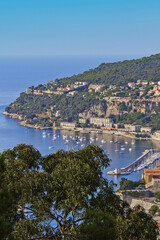 Obraz premium Beautiful top view of Villefranche-sur-Mer bay with boats and yacht. Villefranche-sur-Mer is luxury resort on the French Riviera at Mediterranean Sea, near Nice. France.