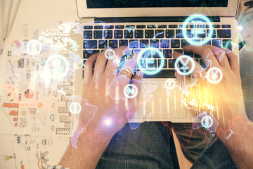 Double exposure of man's hands typing over laptop keyboard and forex chart hologram drawing. Top view. Financial markets concept.