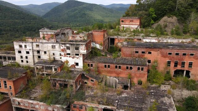 View from above. Flying over the destroyed buildings of the mining and processing plant in the village of Kavalerovo. Abandoned tin mining plant in Russia