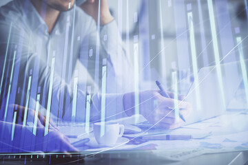 Double exposure of man and woman working together and financial graph hologram. Business concept. Computer background.