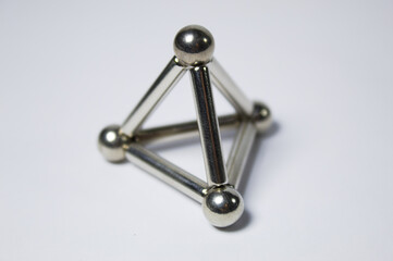 Metal frame with silvery spheres