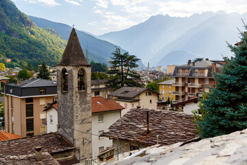 Fototapeta premium Chiavenna, Sondrio, Lombardy, Italy September 16, 2019. Stone tiles on the roofs of the houses of Chiavenna and the chapel of the Church.