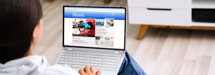 Watching News On Laptop Computer Screen Online