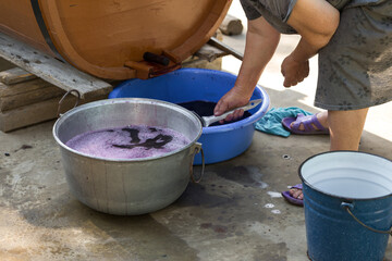 The winemaker pours grape juice for transportation into barrels.