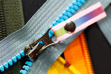 Zip background texture of zippers sliders. a lot of zippers in different colors. sewing clothes,...