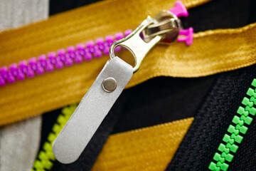 Zip background texture of zippers sliders. a lot of zippers in different colors. sewing clothes,...