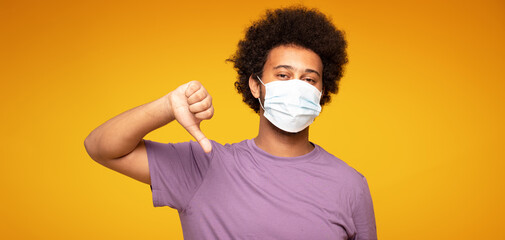 Afro man wearing medical mask .