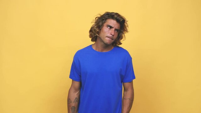 Young cool australian man confused, feels doubtful and unsure