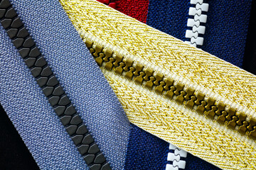 Zip background texture of zippers sliders. a lot of zippers in different colors. sewing clothes,...