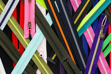Zip background texture of zippers sliders. a lot of zippers in different colors. sewing clothes,...