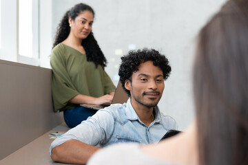 Friendly brazilian teammates having a meeting in co-working open space. Teamwork, corporate, planning, strategy concept..