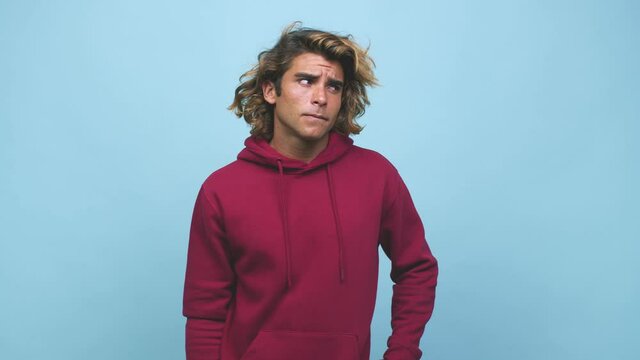 Young cool australian man confused, feels doubtful and unsure