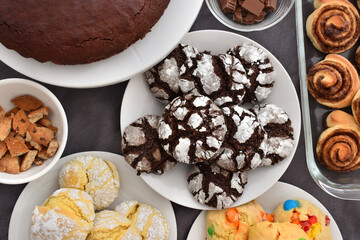 Perfect mix of desserts, freshly baked chocolate cookies, delicious cinnamon rolls, chocolates, brownie, vanilla cookies and lemon with chips cookies for a any occasion with friends in home