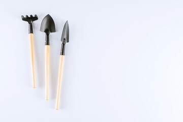 Gardening tools, shovel and rake on white background. Copy space.