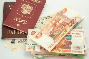 Passports of Russian citizen and ruble banknotes in cash are on train tickets