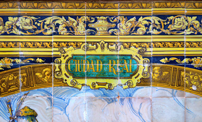 Tile with the name of the spanish city of Ciudad Real on ceramic  with a colorful decoration located in Spain Square in Seville