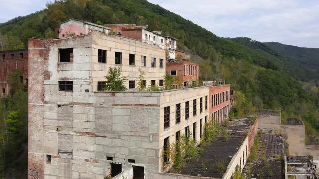 View from above. Abandoned tin mining plant in Russia. Flying over the permitted buildings of the mining and processing plant in Kavalerovo