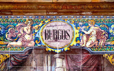 Tile with the name of the spanish city of Burgos on ceramic  with a colorful decoration located in Spain Square in Seville