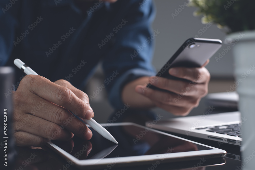 Poster multitasking businessman using mobile phone, digital tablet and laptop computer busy working from ho