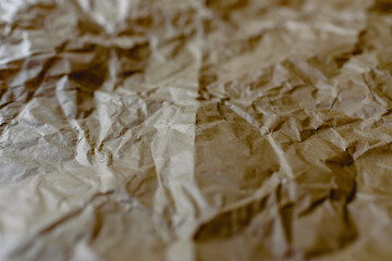 Crumpled and expanded paper with natural texture of reddish tones.
