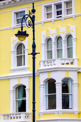Fototapeta na wymiar Vintage Lamp Post and Colourful Building in Llandudno, Wales