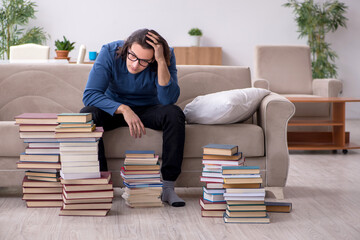 Young male student preparing for exams at home