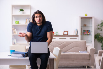 Young man employee working from house