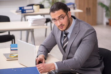 Young male employee working in the office