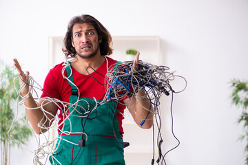 Funny young male electrician working indoors