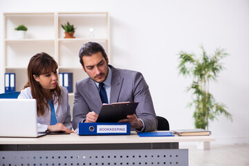 Young female doctor and sick businessman in the office