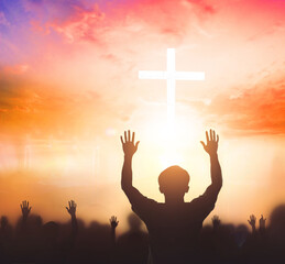 Worship concept: christian people Raise hand over cross on spiritual sky background