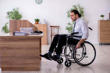 Young disabled employee suffering at workplace